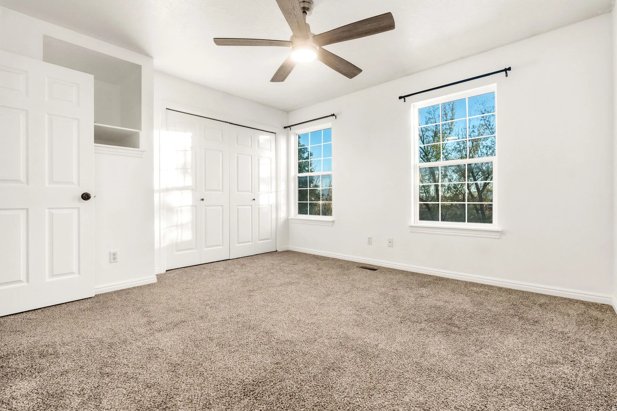 Unfurnished bedroom with carpet floors, a ceiling fan, and a closet