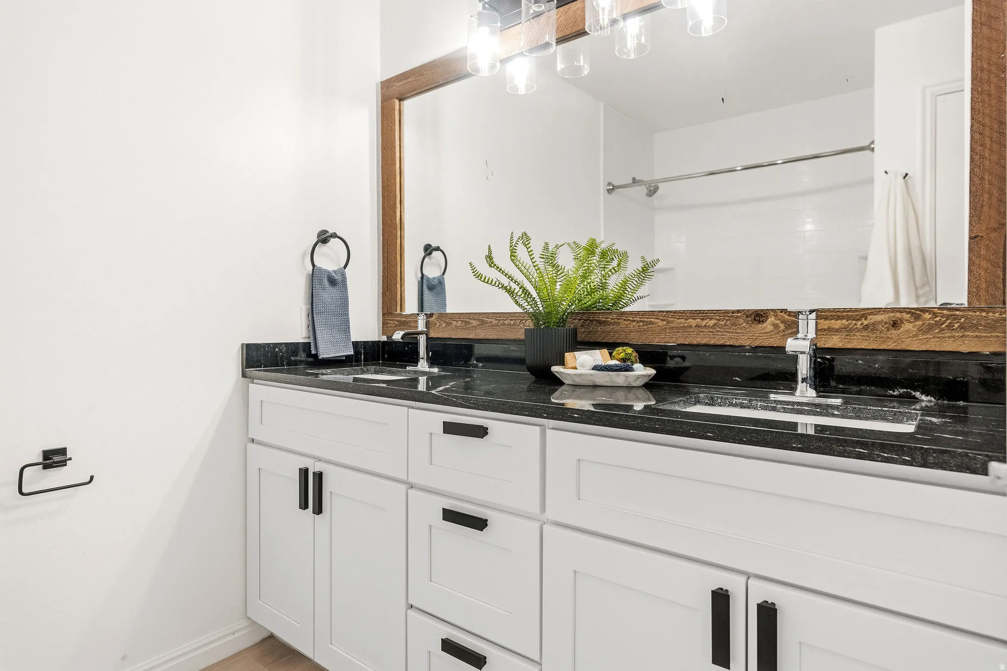 Full bath featuring double vanity and curtained shower