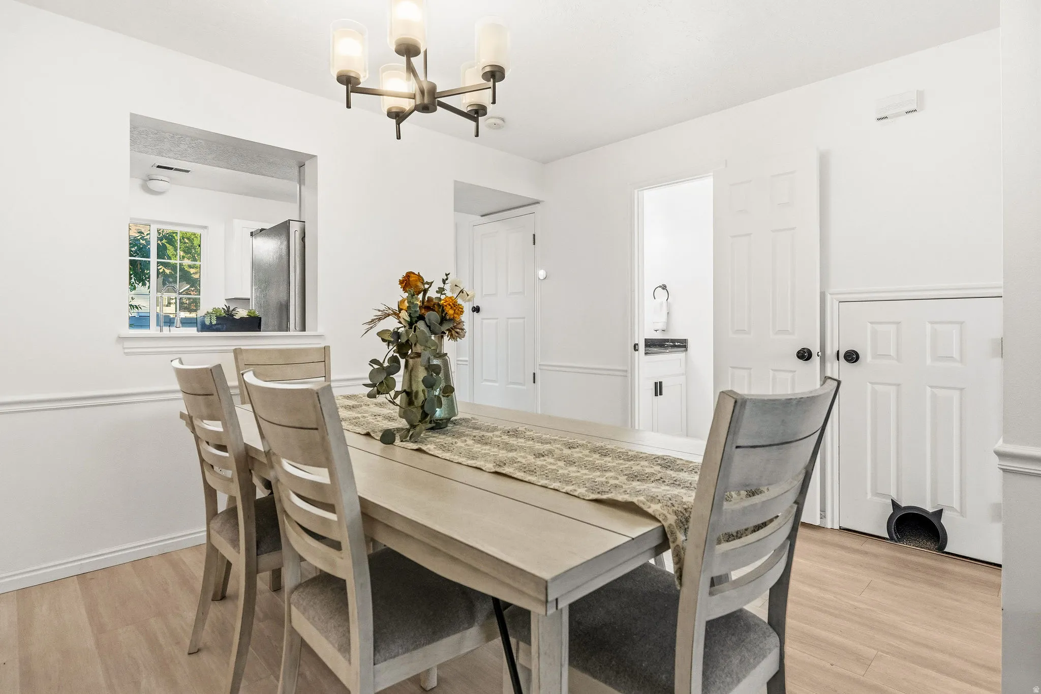 Dining room featuring light wood-style floors and hanging lights