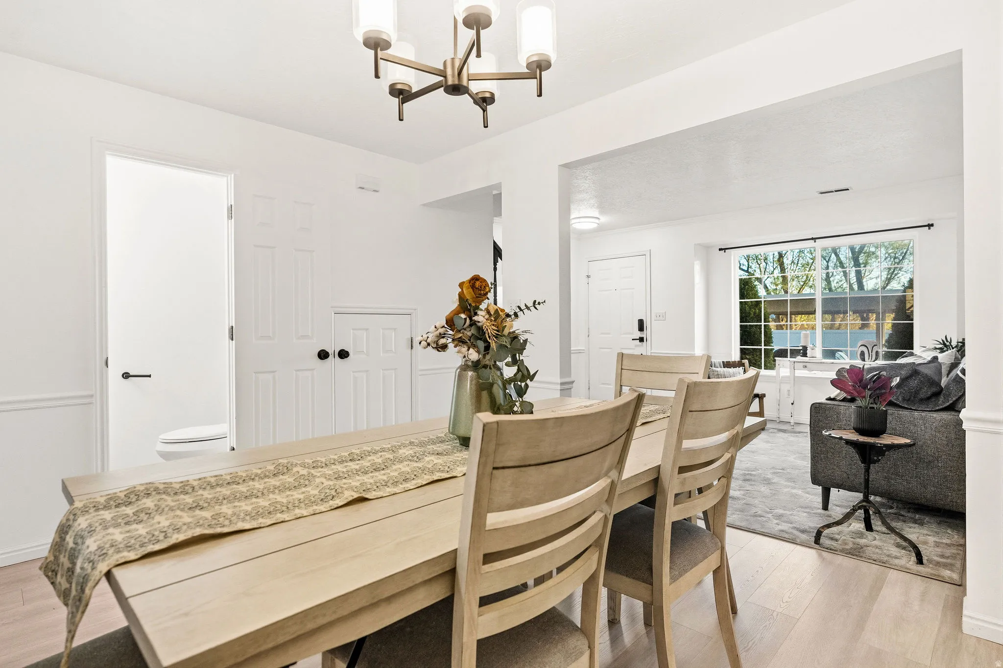 Dining room featuring light wood-style floors and a chandelier