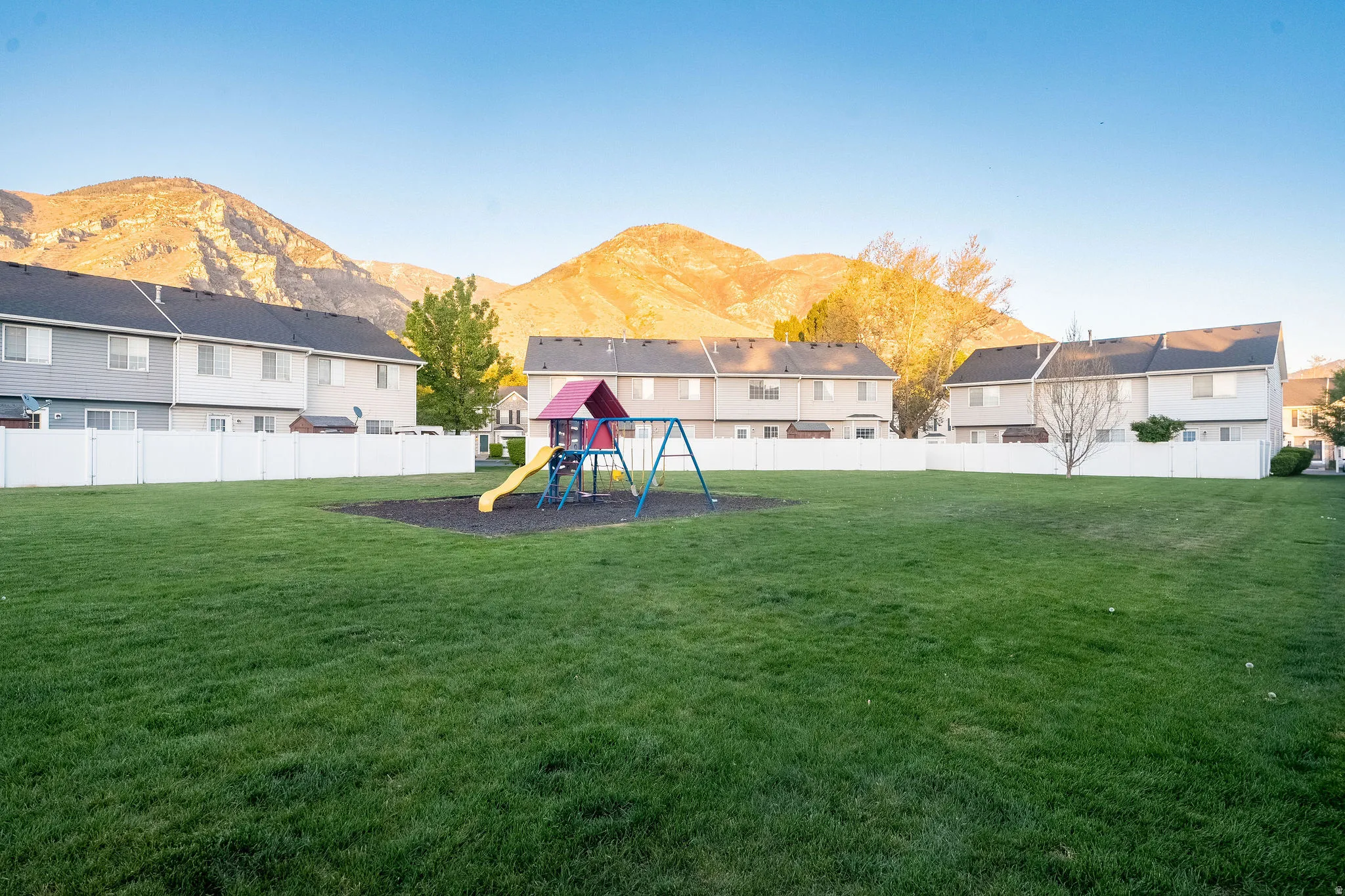 Fenced yard featuring a mountain view and a residential view