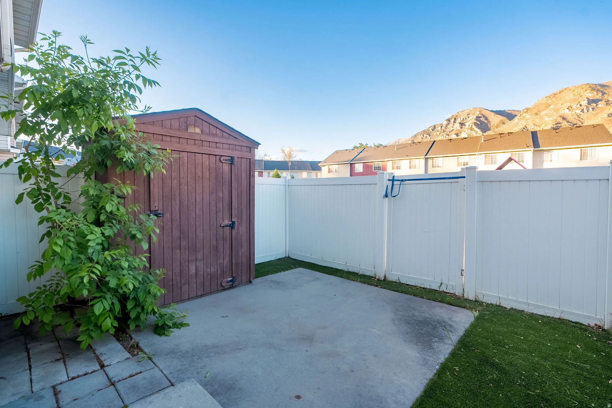 Fenced backyard with a storage shed