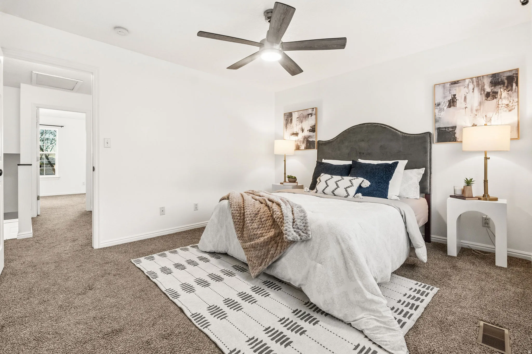 Bedroom featuring dark carpet and a ceiling fan