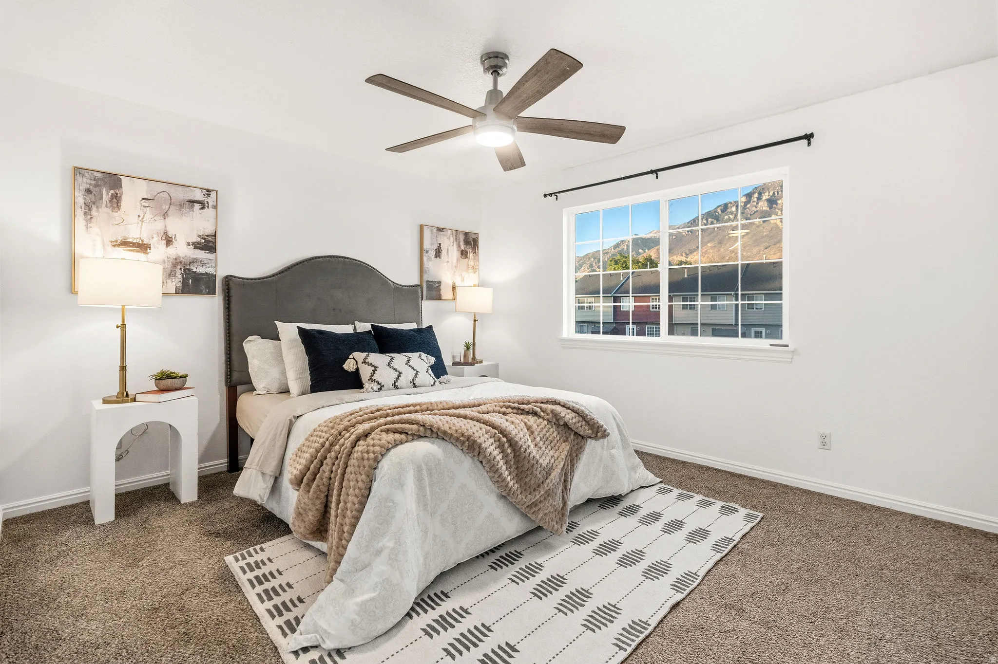 Bedroom featuring ceiling fan and dark carpet