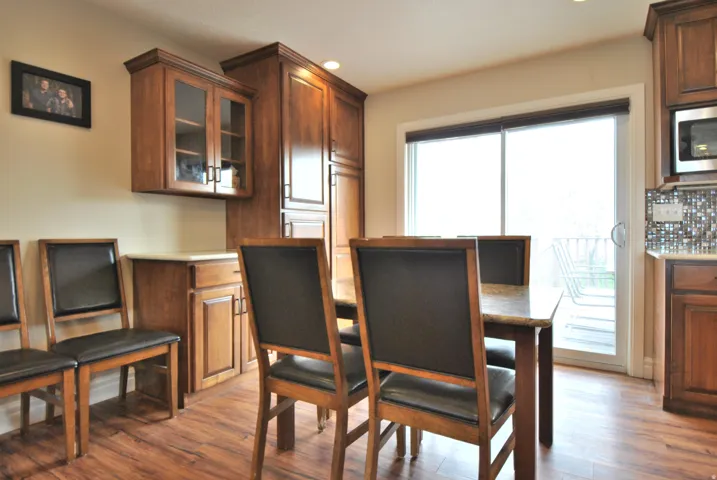 Dining area featuring dark wood-style flooring and recessed lighting