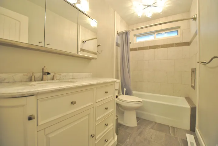 Full bathroom featuring vanity and shower / tub combo