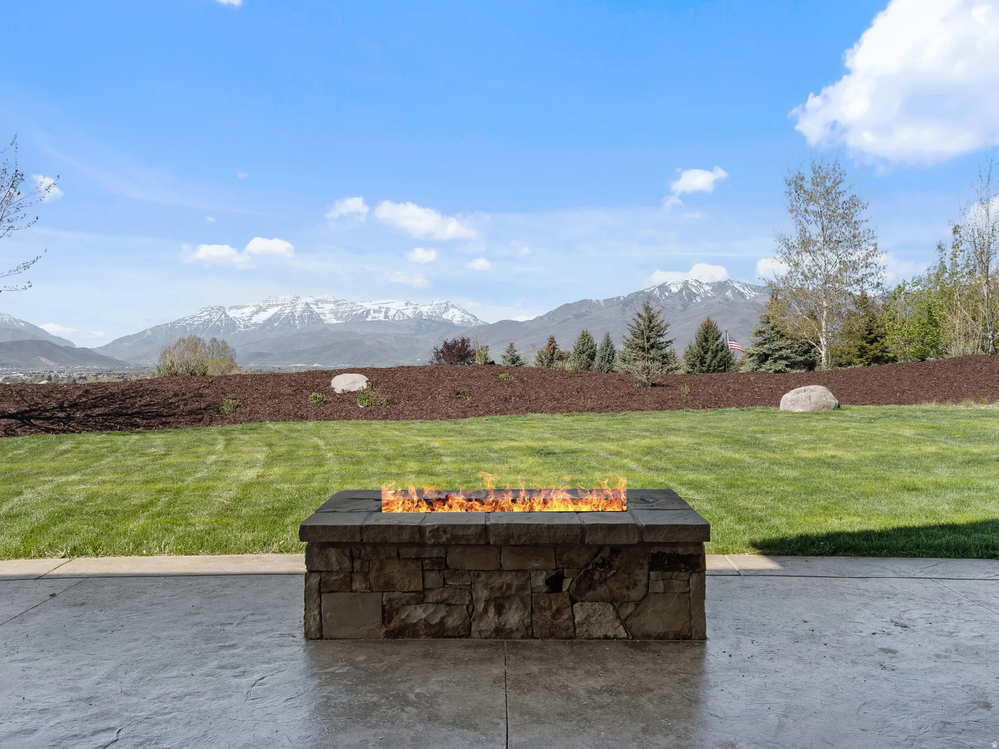 View of patio featuring a fire pit and a mountain view
