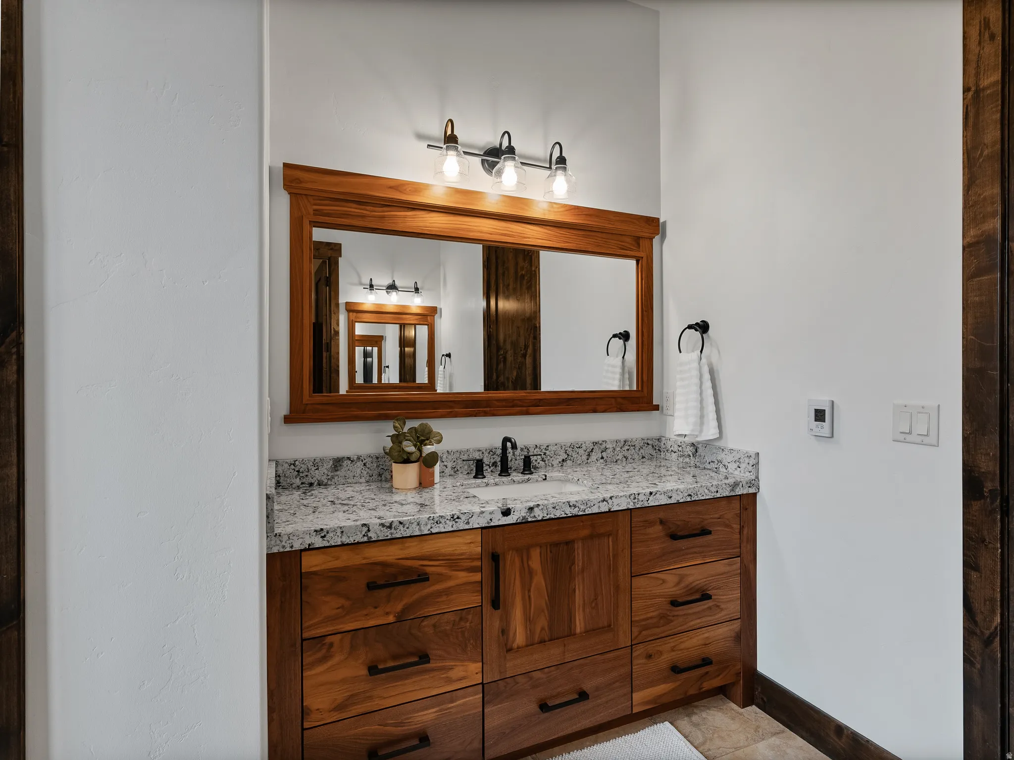 Bathroom featuring vanity and baseboards
