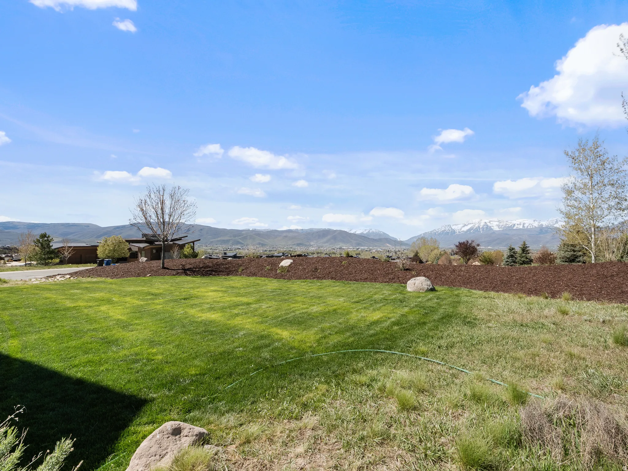 View of grassy yard featuring a mountain view