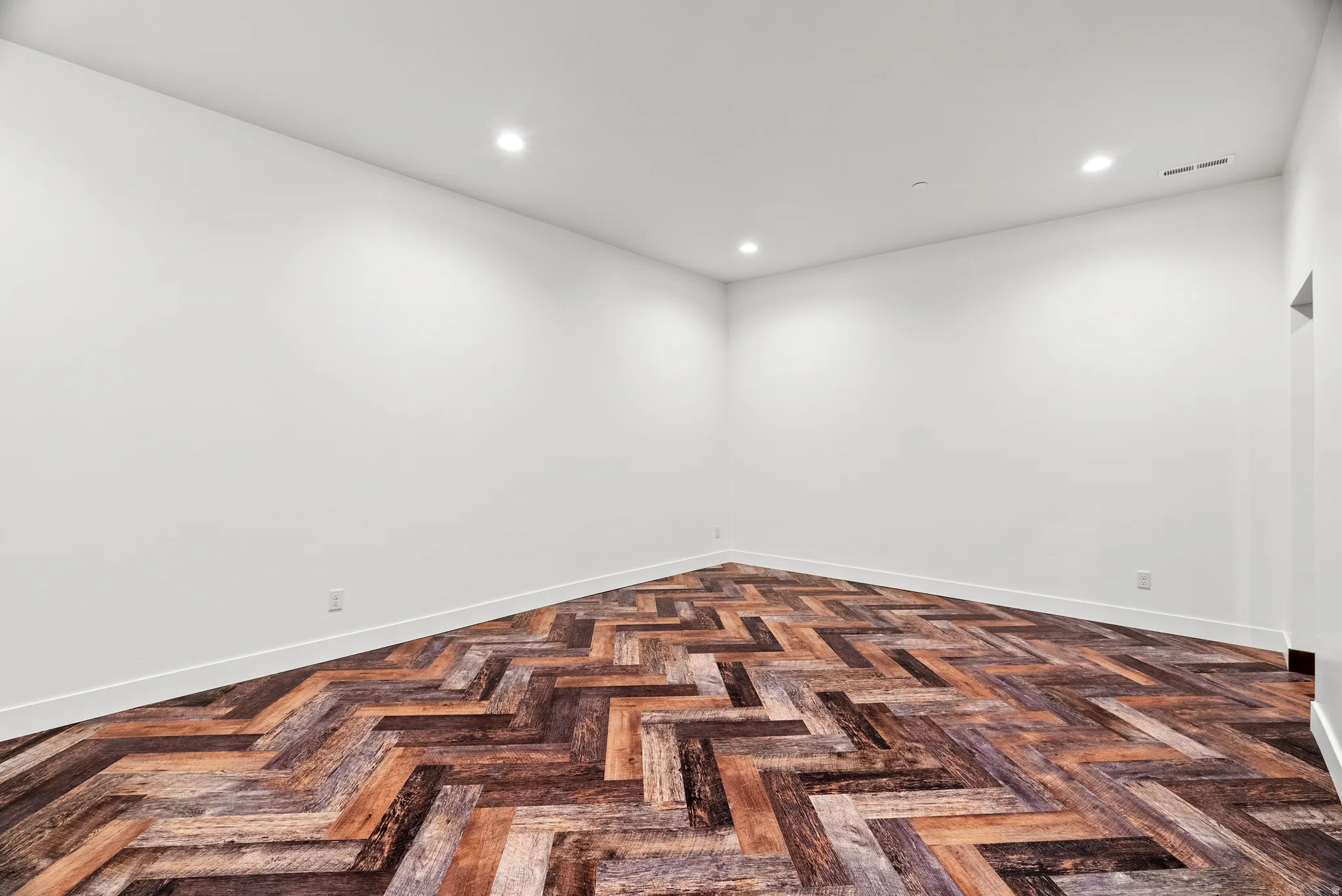 Spare room with parquet flooring and recessed lighting