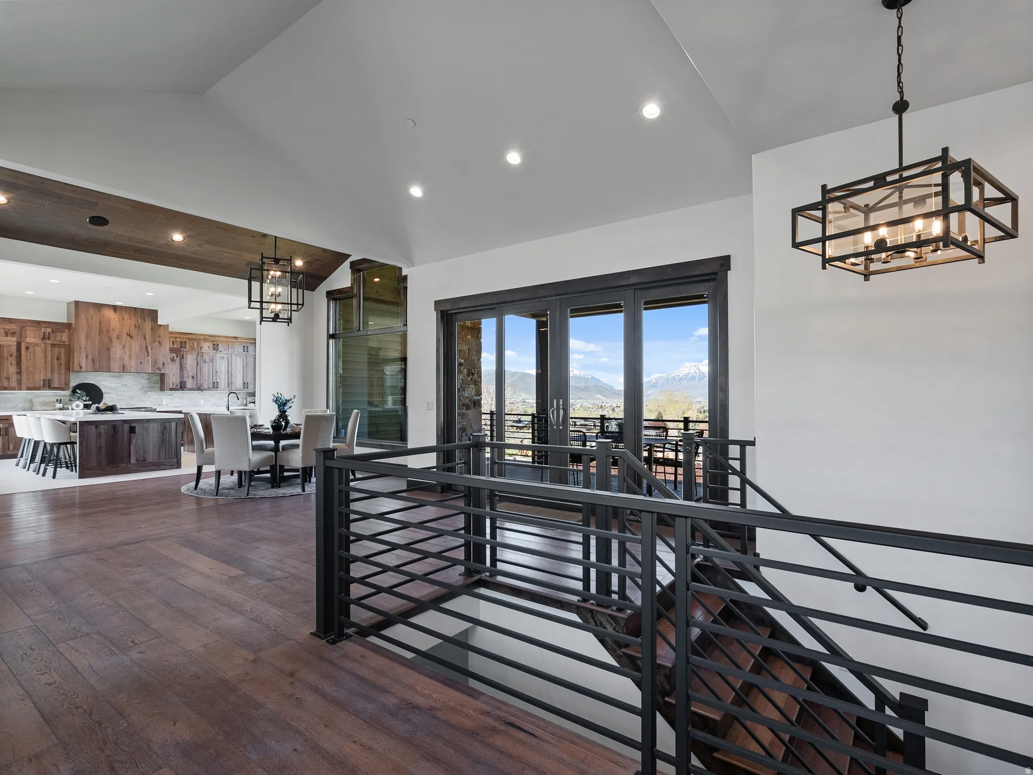 Interior space with hanging lights, dark wood-type flooring, and vaulted ceiling