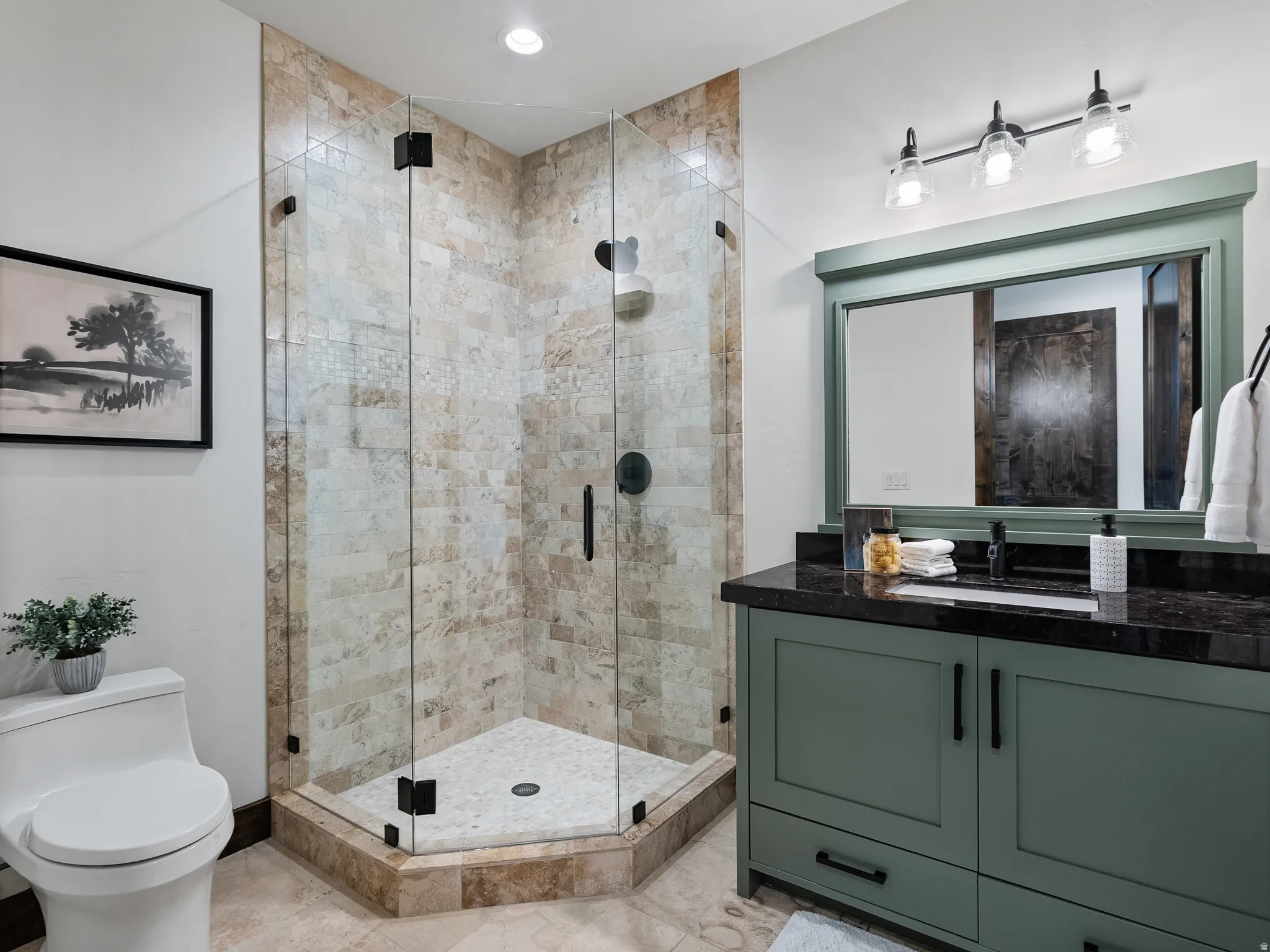 Full bathroom with vanity, a shower stall, and recessed lighting