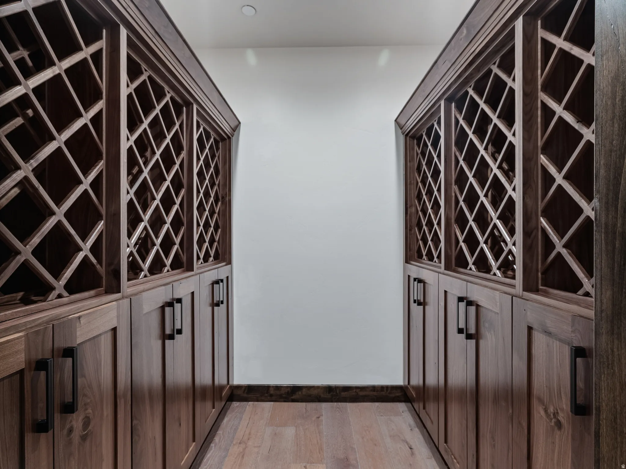 Wine area with light wood finished floors and baseboards