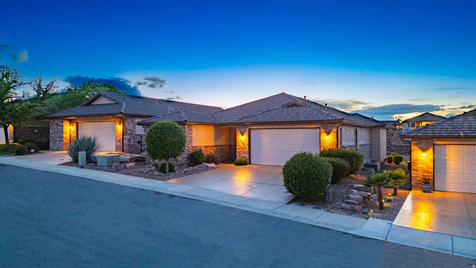View of front of property featuring an attached garage and driveway