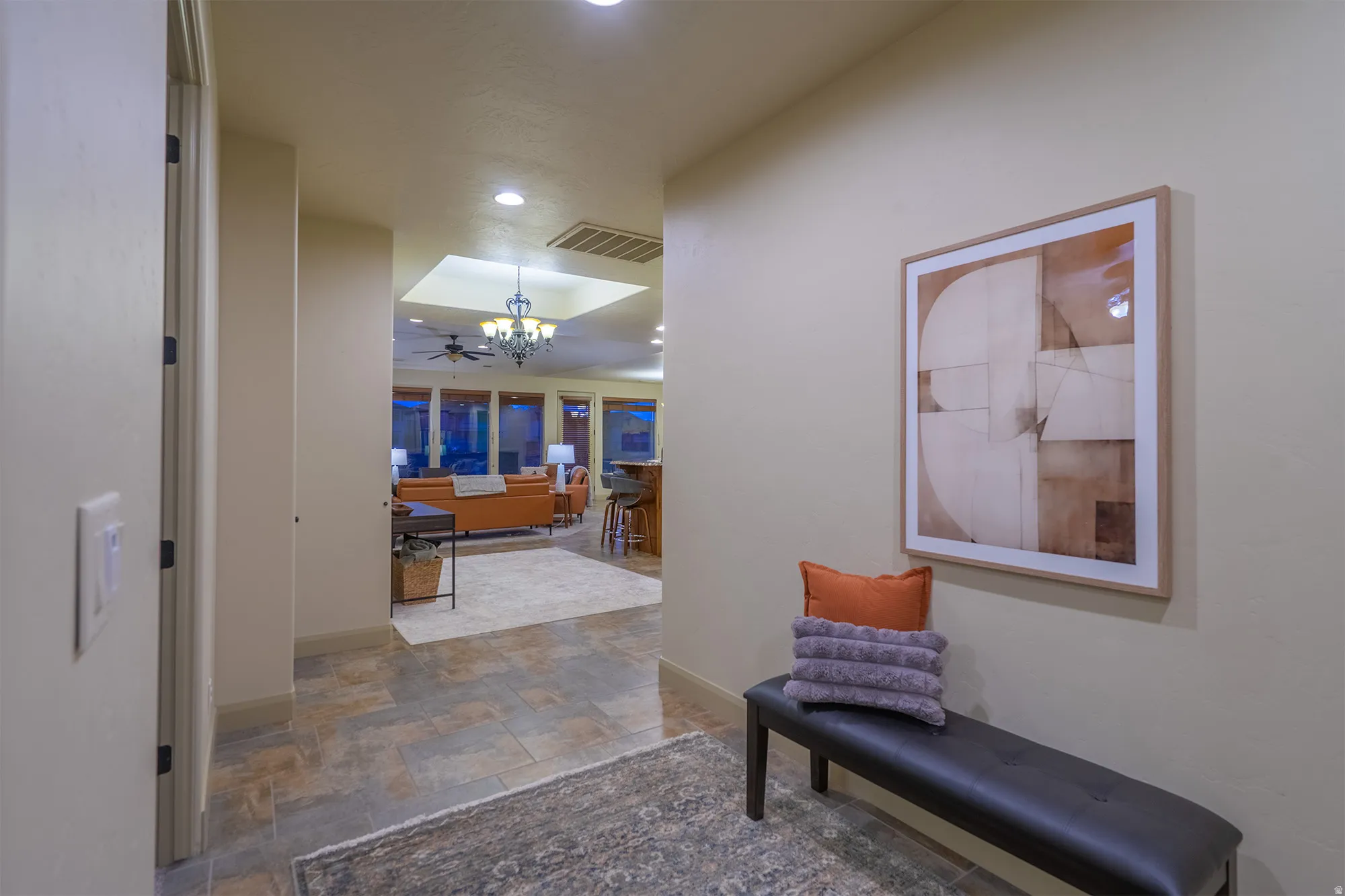 Hall with stone finish floors and hanging lights