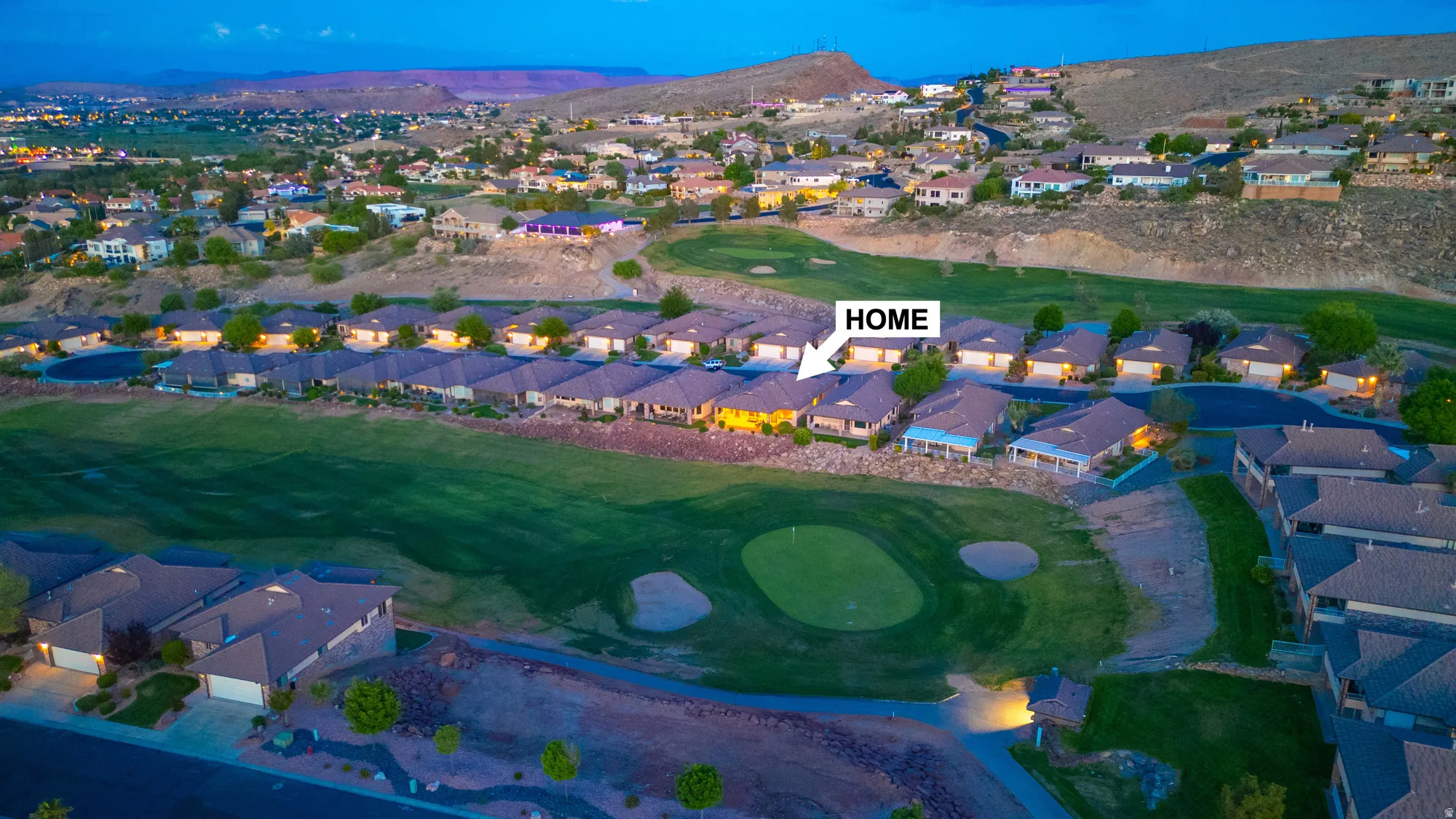 Aerial view of residential area featuring a local golf course and mountains