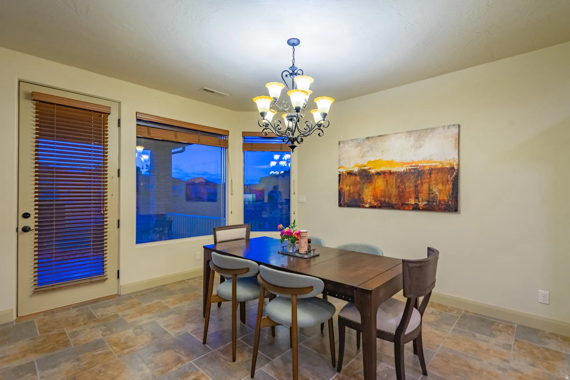 Dining room with stone finish flooring and suspended lighting