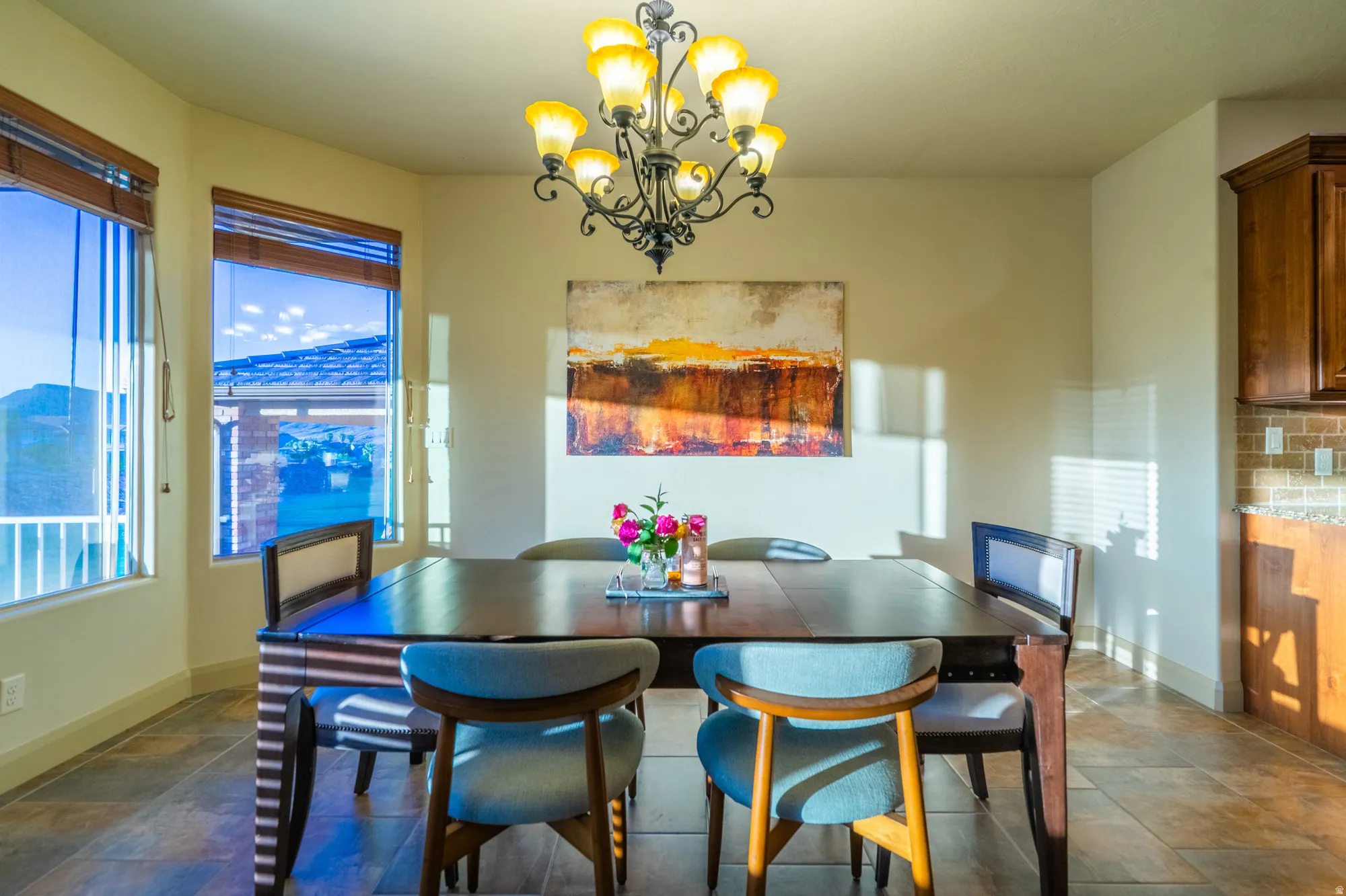 Dining area with stone tile floors and a chandelier