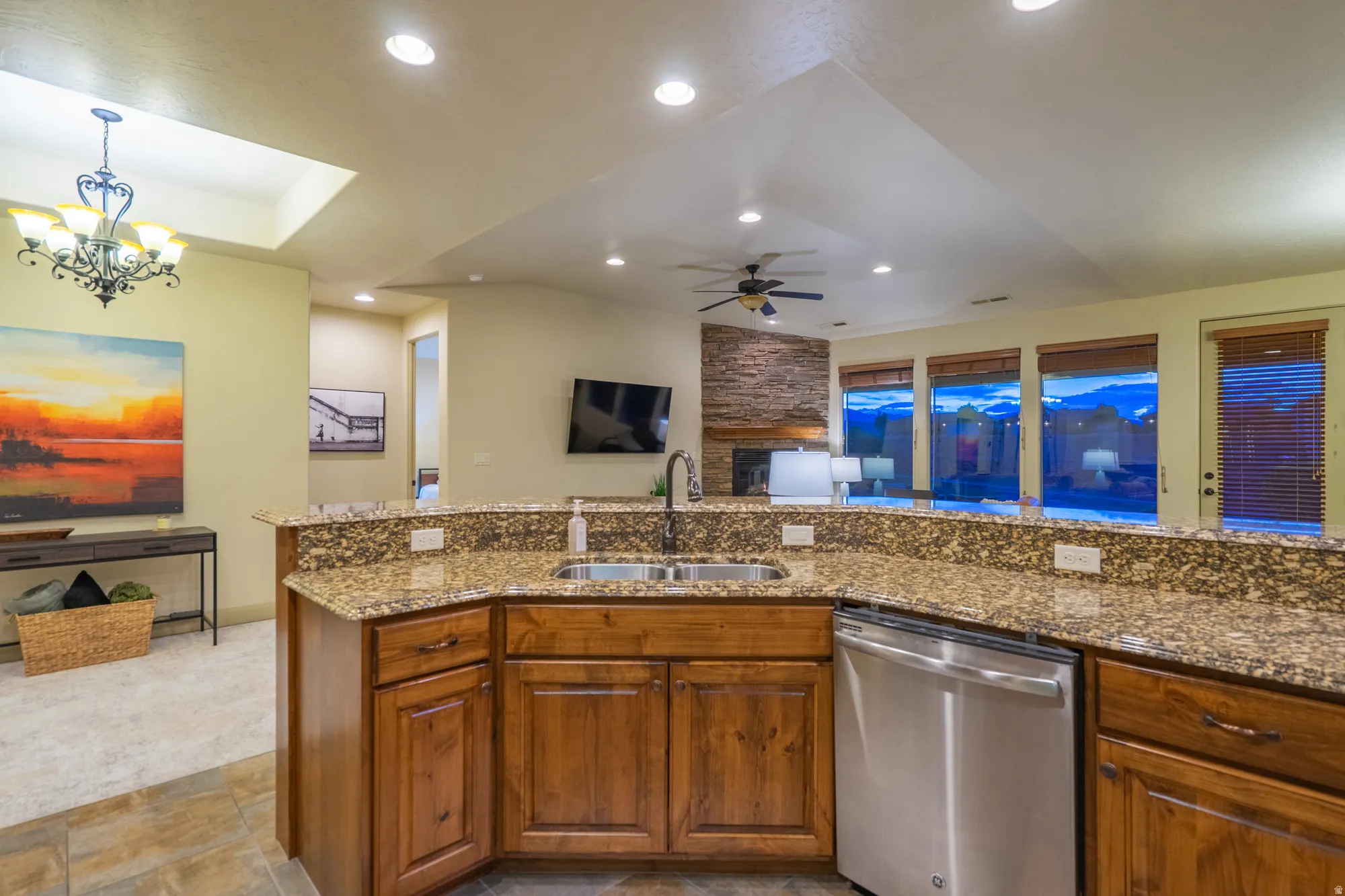 Kitchen with open floor plan, dishwasher, wood finish cabinets, and ceiling fan