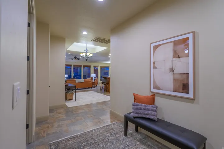 Hall with stone finish floors and hanging lights
