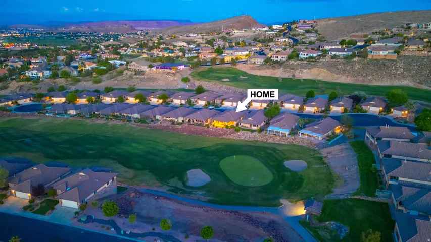 Aerial view of residential area featuring a local golf course and mountains