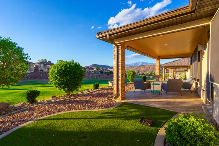 View of grassy yard featuring outdoor furniture, a patio area, and a mountain view