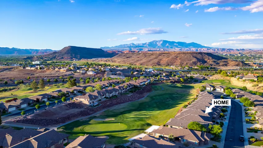 Aerial perspective of suburban area with mountains and a local golf course