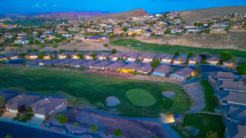 Aerial view of residential area featuring a golf club and mountains
