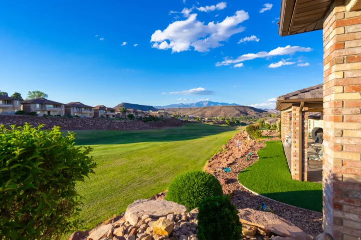 View of grassy yard with a mountain view