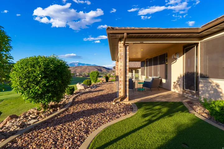View of grassy yard with a patio and a mountain view