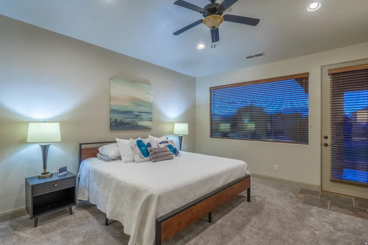 Bedroom featuring ceiling fan, carpet, and access to outside