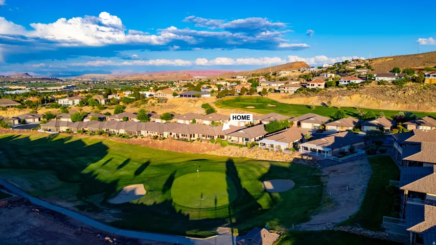 Aerial view of residential area with mountains and a golf course