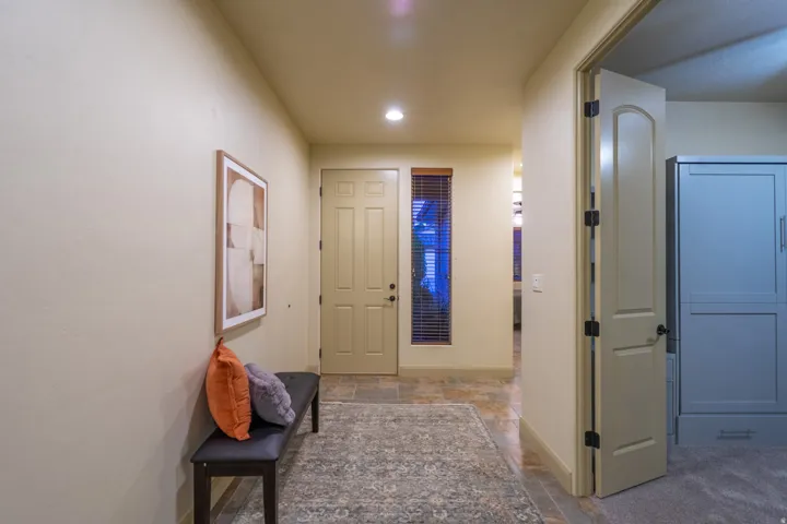 Foyer entrance with stone tile floors and recessed lighting