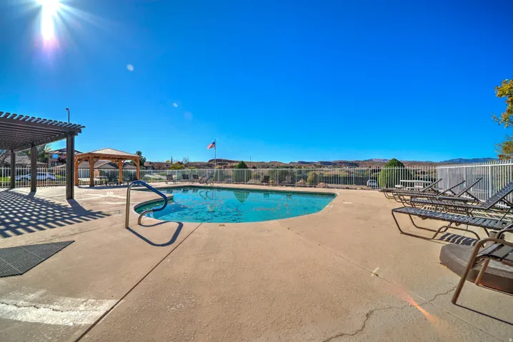 Community pool featuring a patio and a pergola