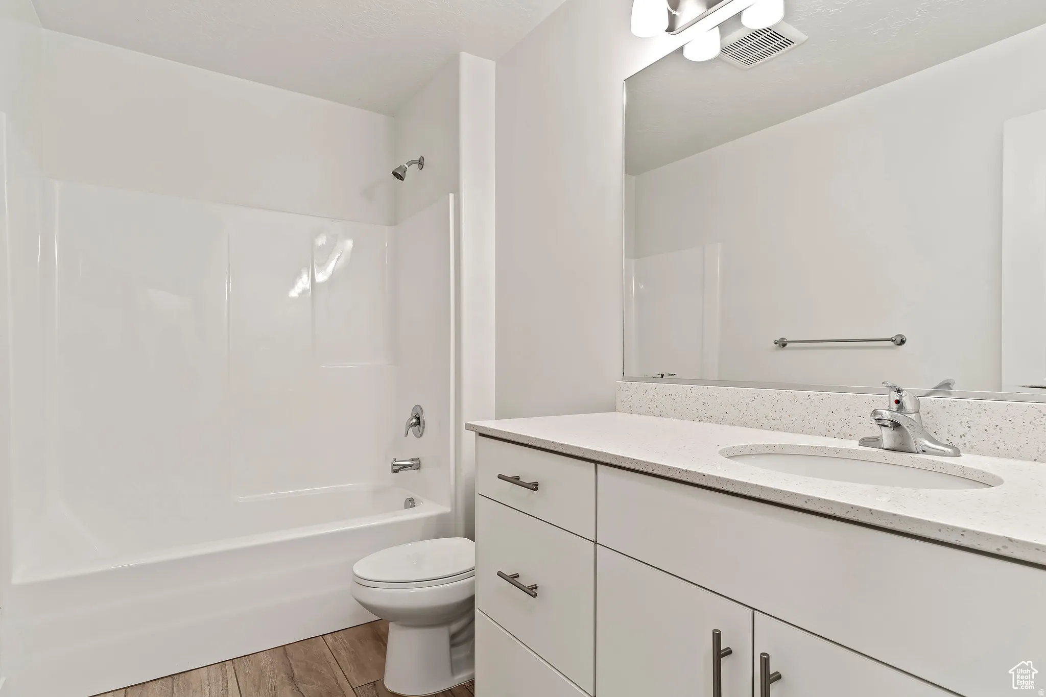Full bathroom featuring vanity, light wood-style floors, and shower / bath combination