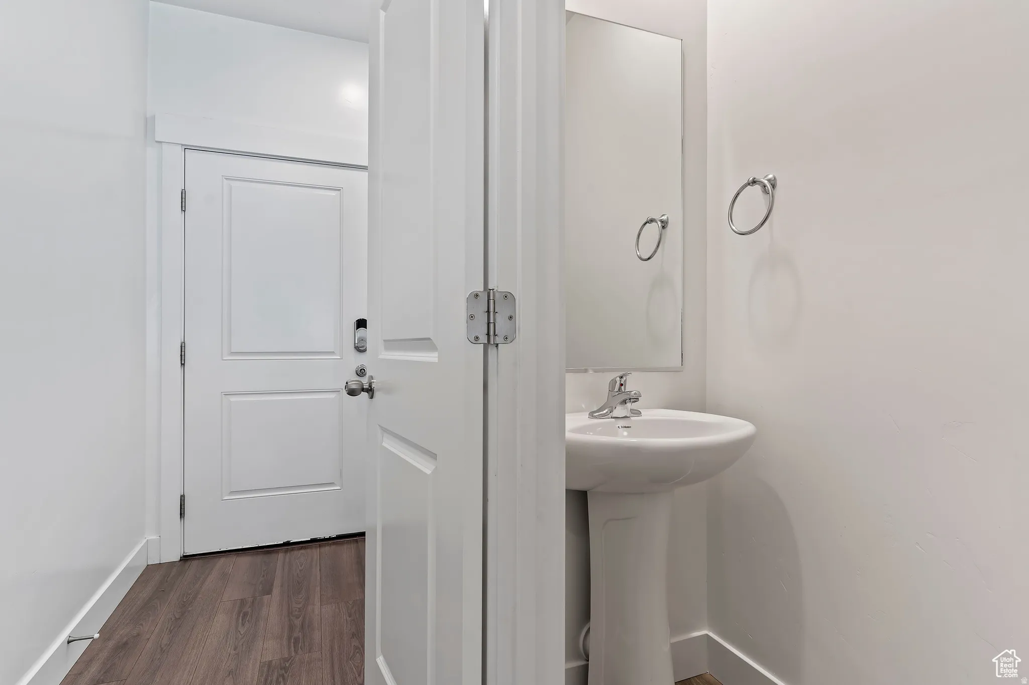 Bathroom featuring dark wood finished floors and baseboards