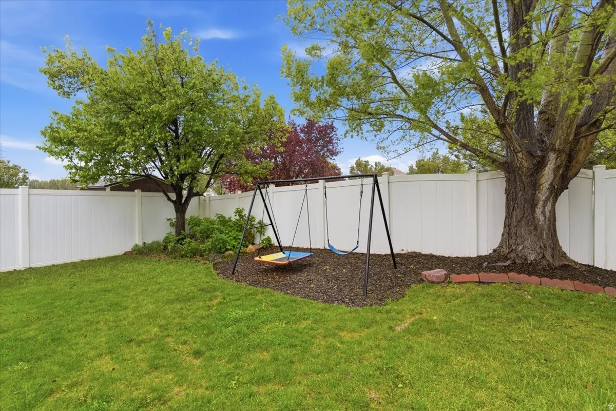 Fenced backyard with a playground