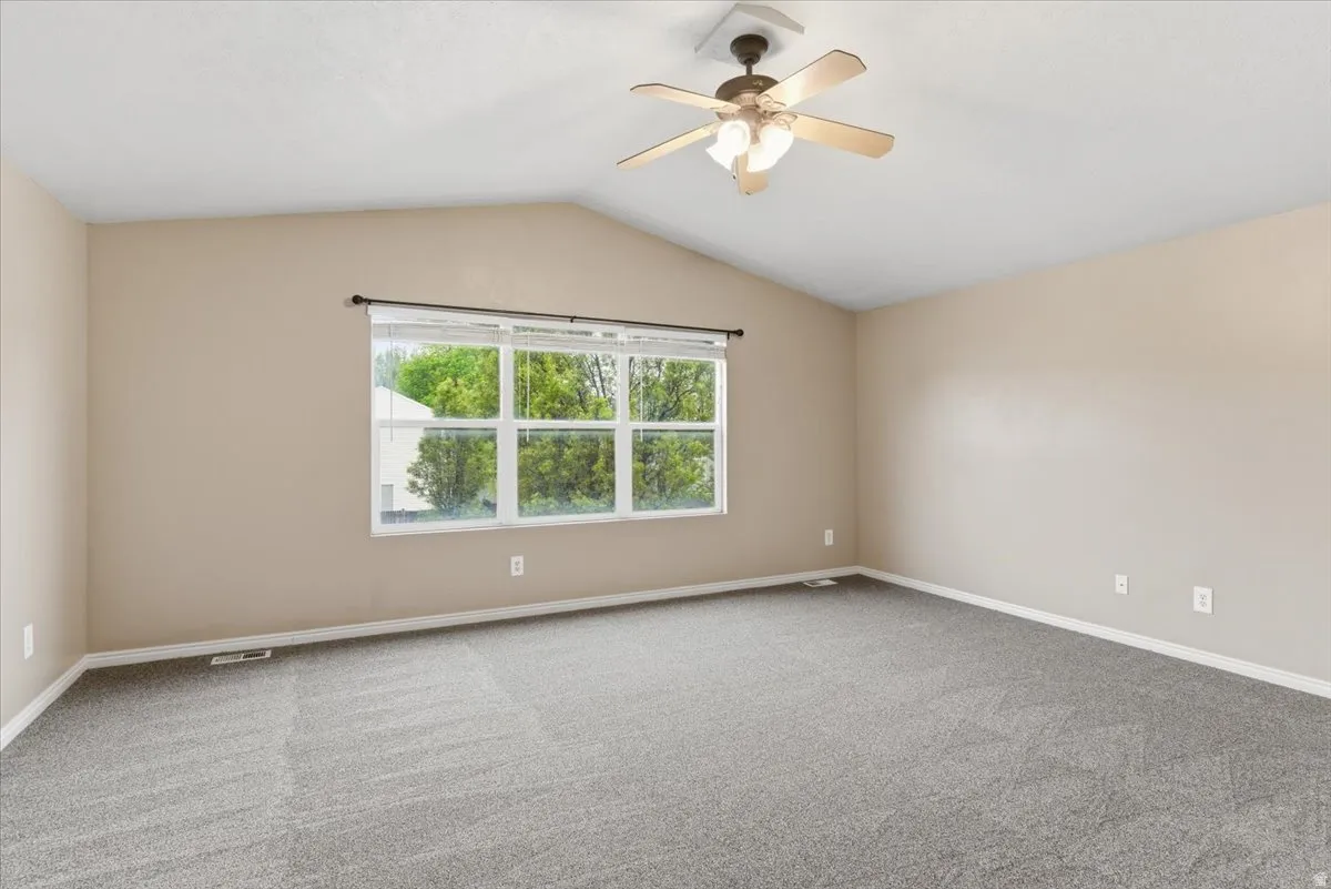 Spare room with carpet flooring and ceiling fan