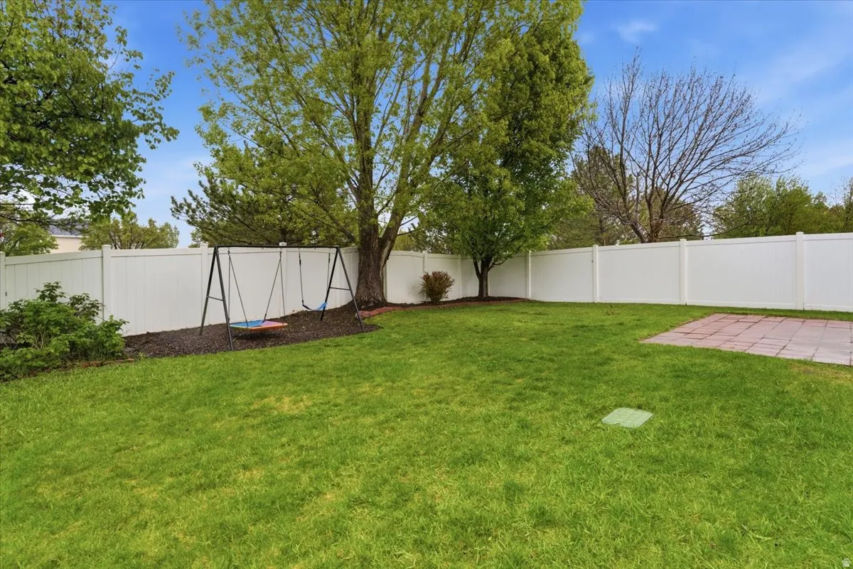 Fenced backyard featuring a patio