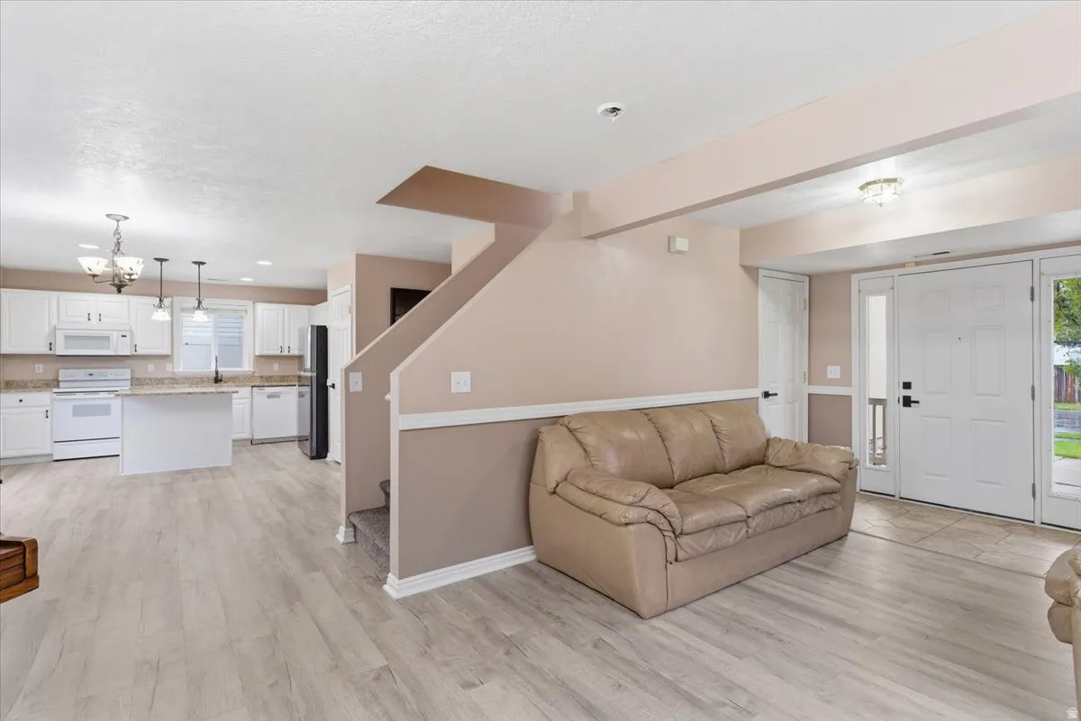Living room with a chandelier and light wood-style floors