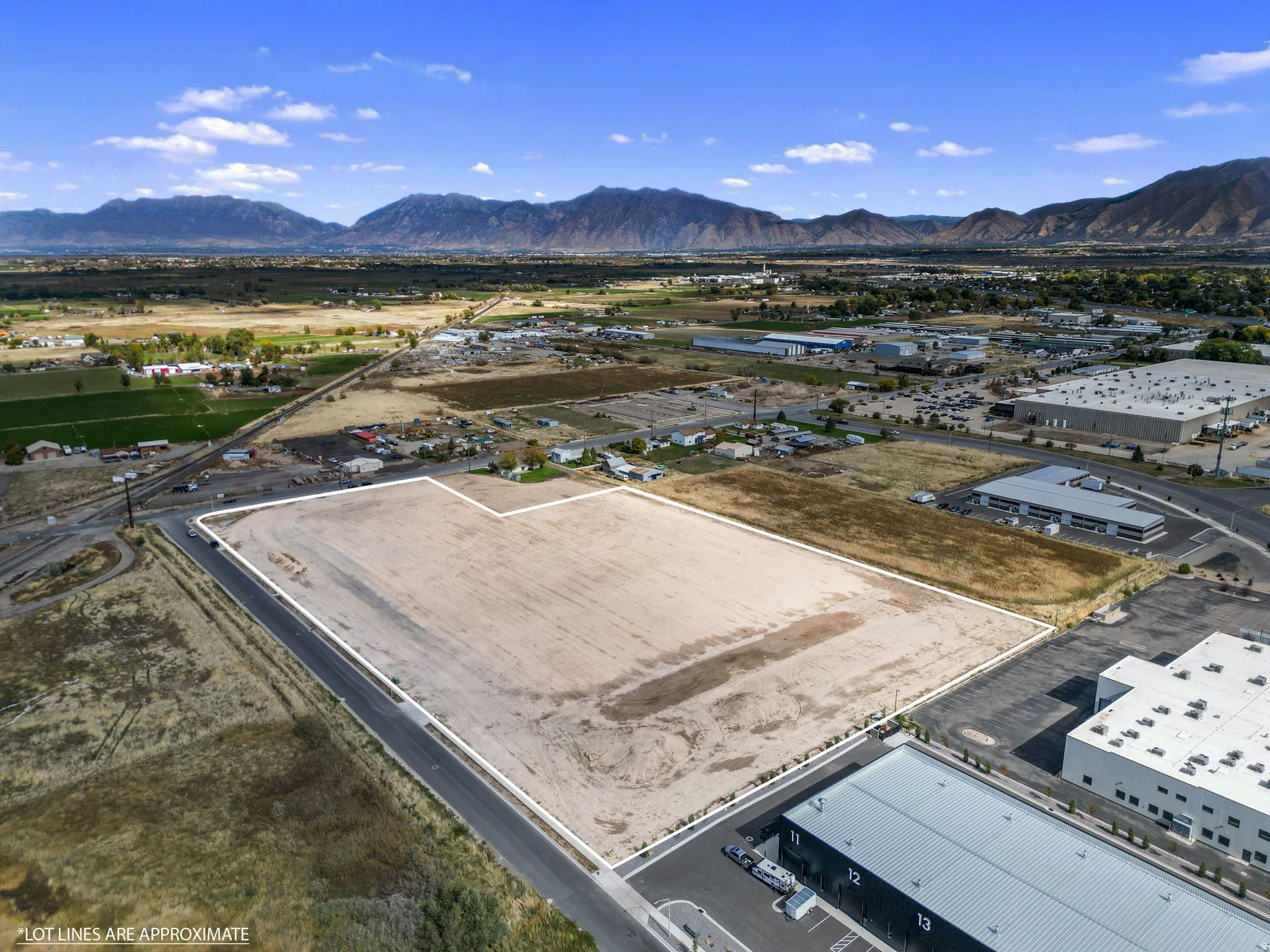 Aerial overview of property's location featuring a mountainous background and property boundaries highlighted