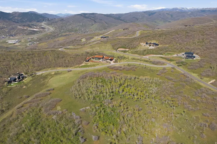 Aerial view of property's location featuring a mountainous background and rural landscape