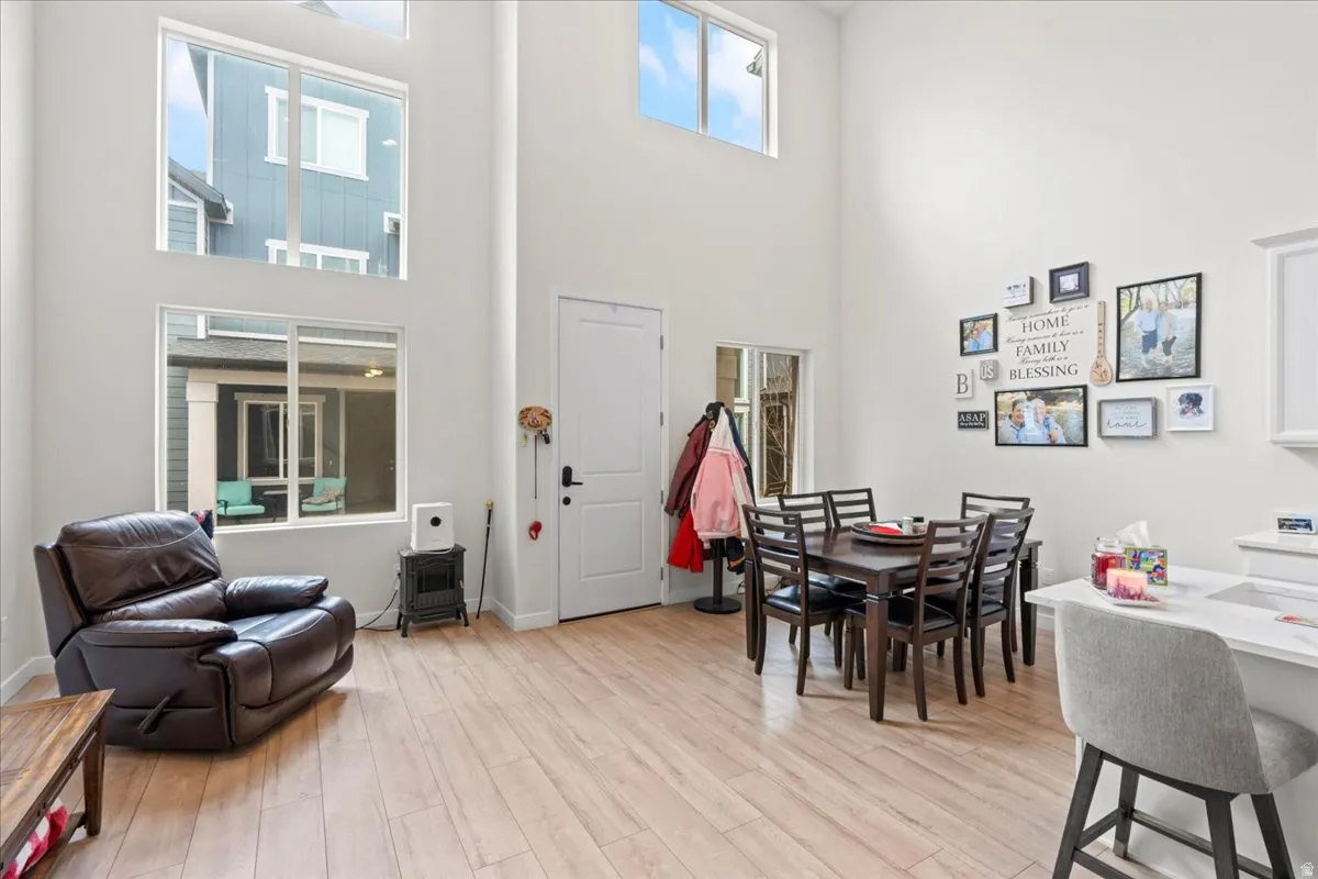Dining room featuring light wood finished floors and a high ceiling