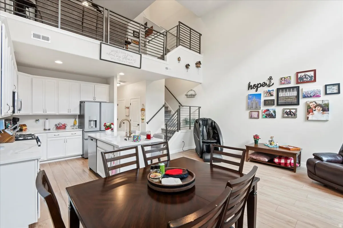 Dining room featuring a high ceiling and light wood finished floors