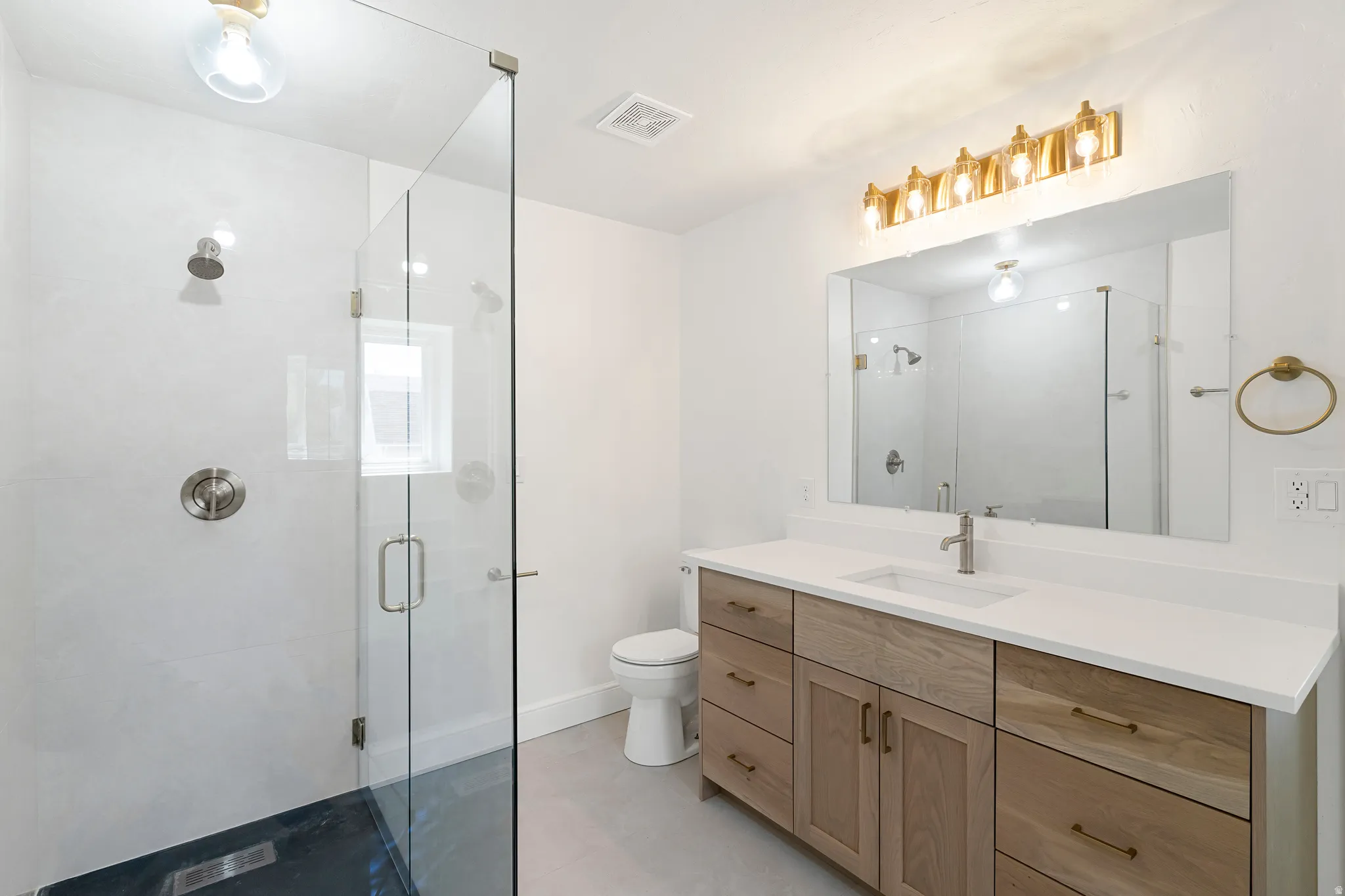 Full bath featuring vanity and a shower stall