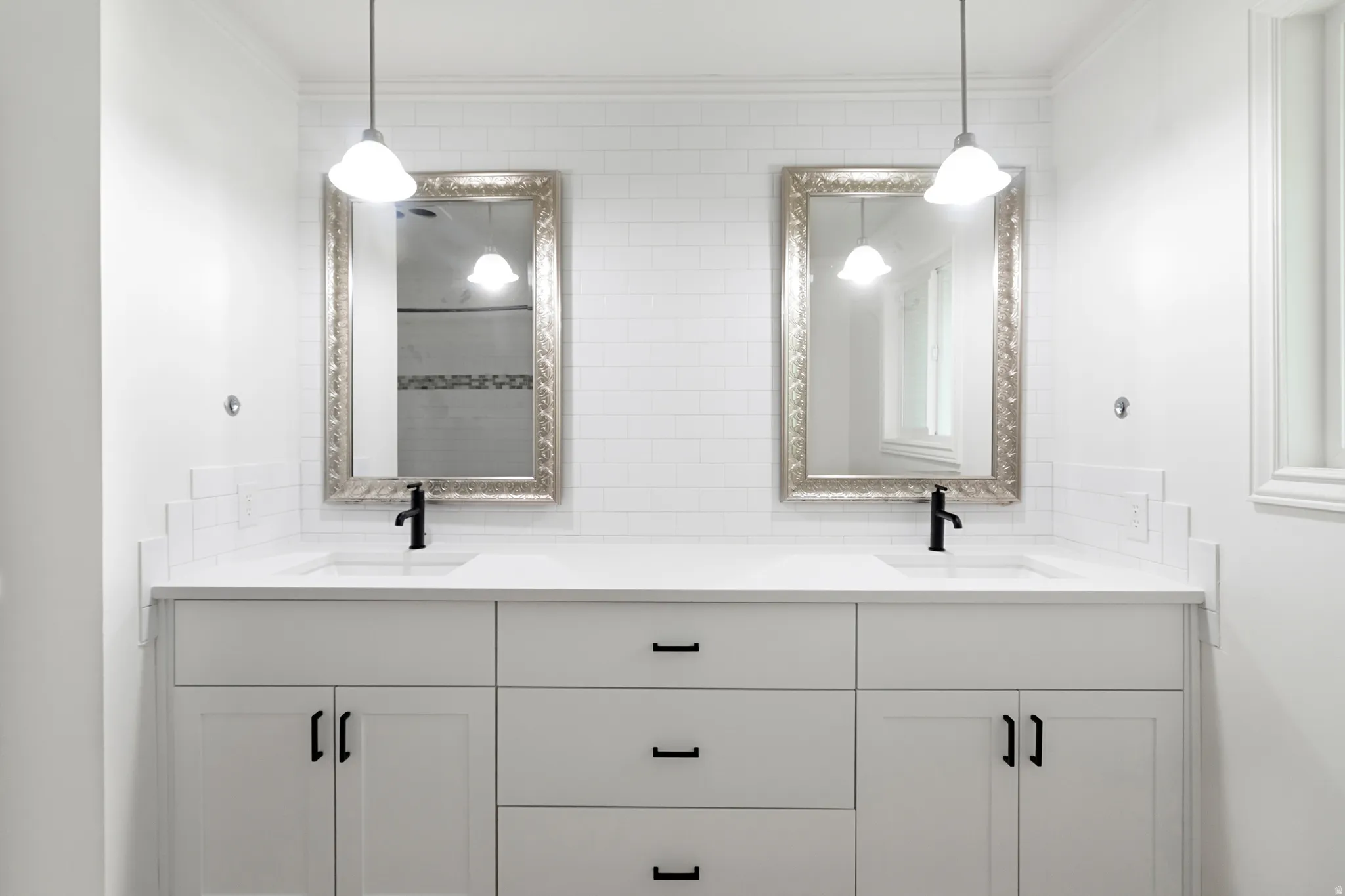 Full bathroom featuring double vanity, crown molding, and backsplash