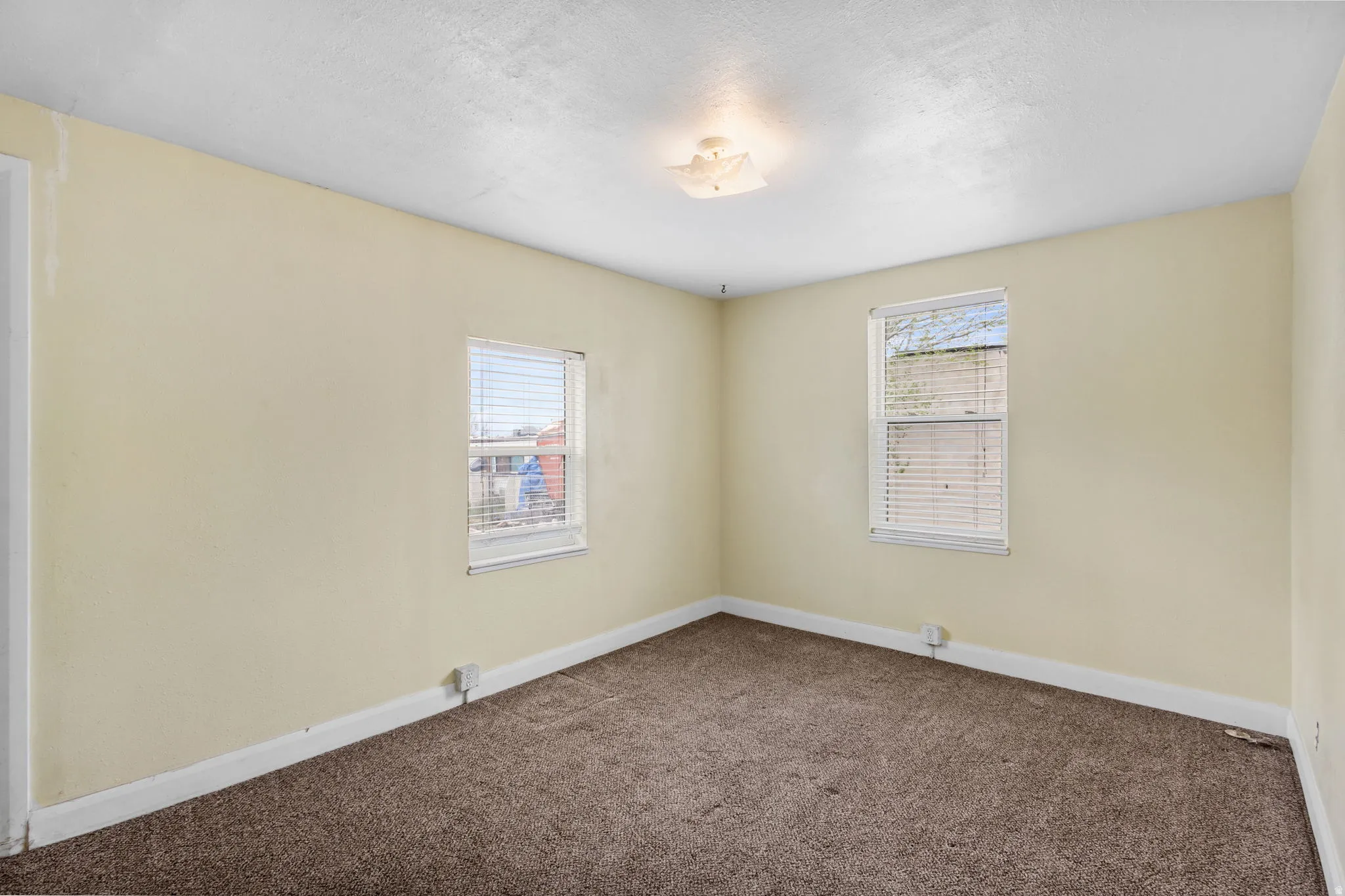 Spare room with healthy amount of natural light and carpet flooring