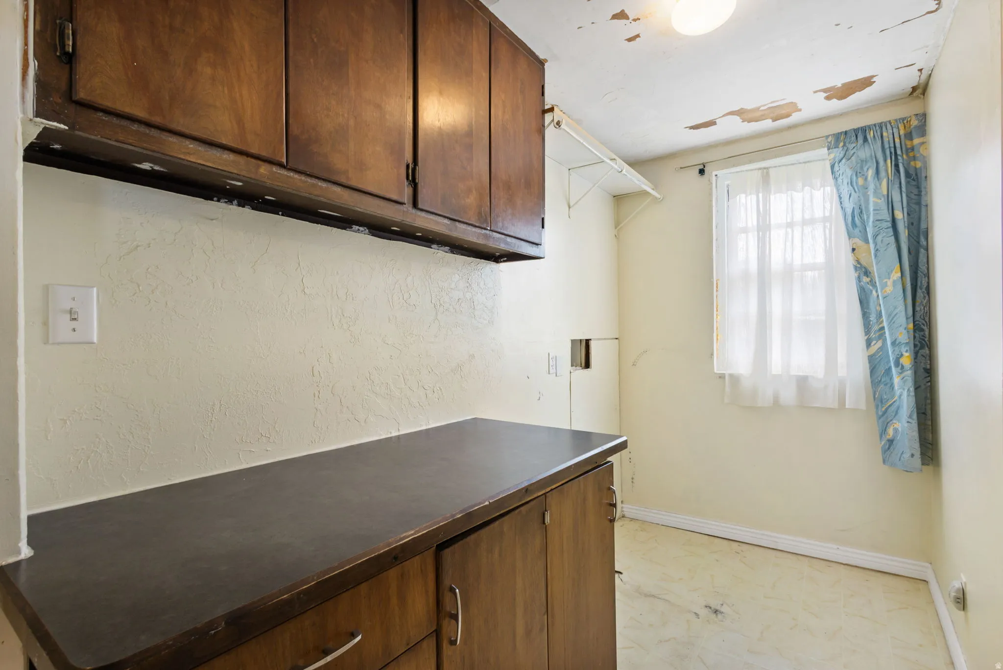 Laundry room featuring baseboards