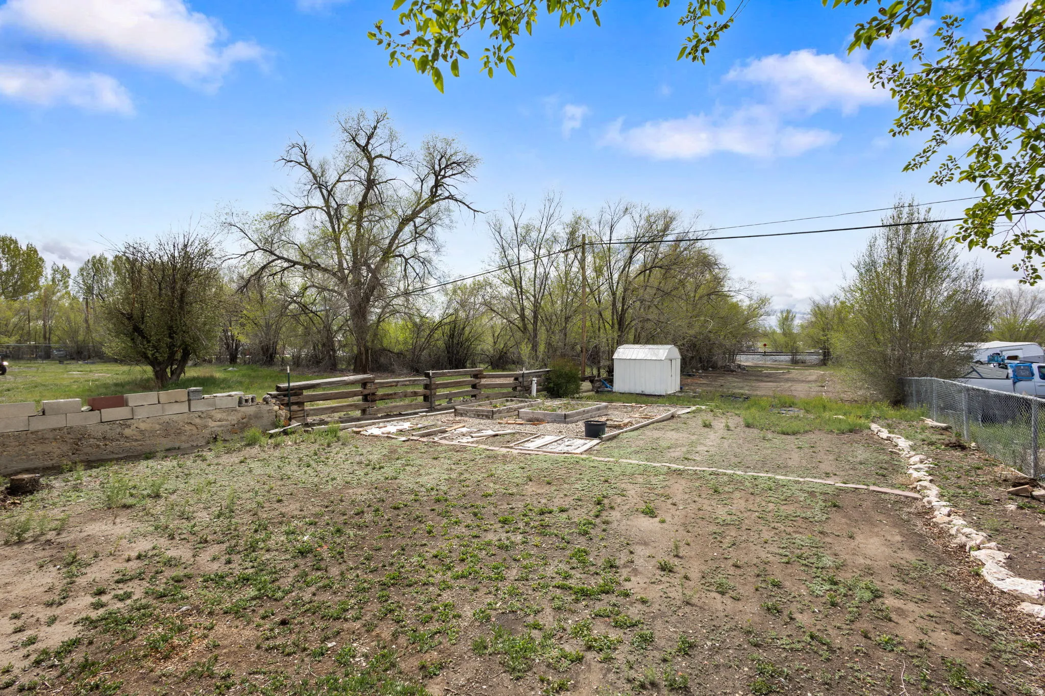 View of yard featuring a shed and a vegetable garden
