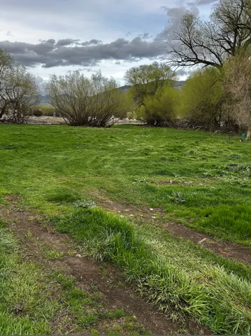 View of green lawn with a view of countryside